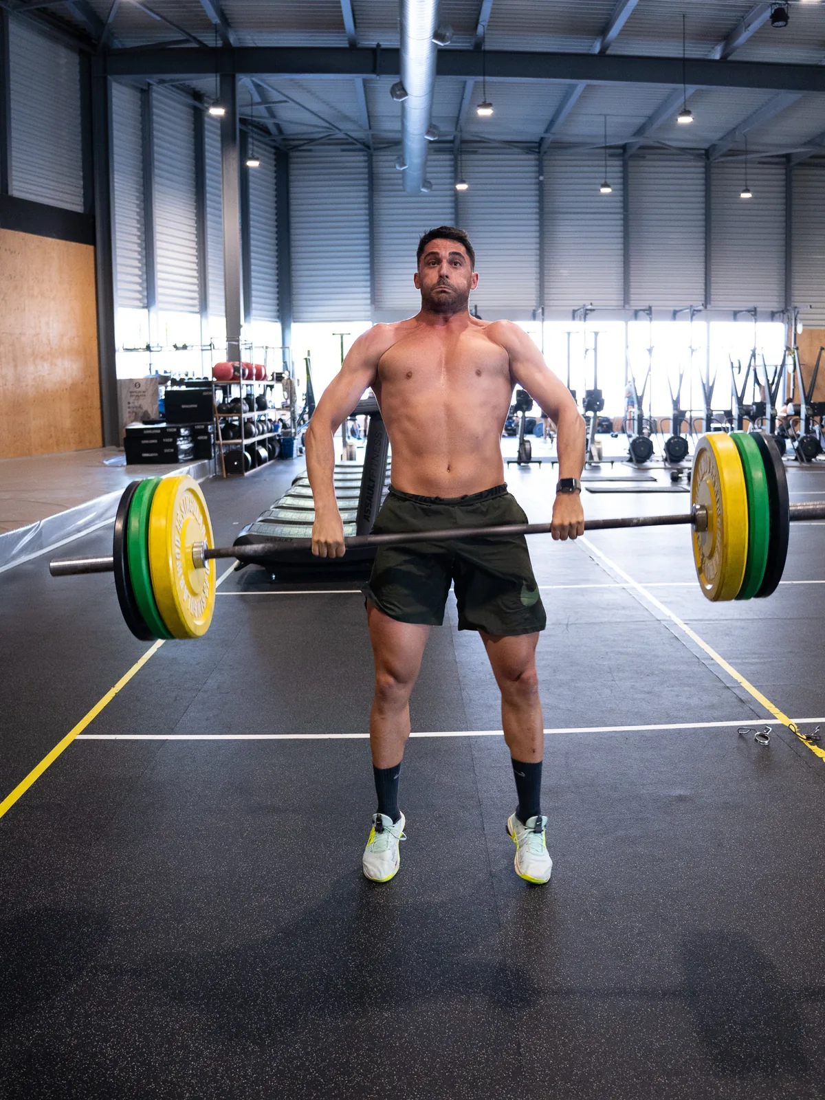 Atleta terminando un peso muerto con la barra cargada en la clase de fuerza de CrossFit Colen